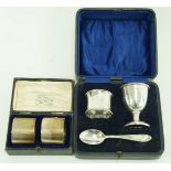 A cased silver christening set, comprising an egg cup, a napkin ring and a spoon,