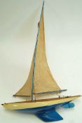 A 1950's pond yacht, painted in blue and cream, named “Eagle”, 110cm high,