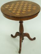 A William IV mahogany tripod table with marquetry chess board top and two hidden frieze sliding