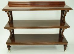 A Victorian mahogany three tier buffet with raised back, scroll and turned supports on turned legs,