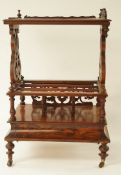A Victorian walnut Canterbury/ side table with pierced and turned supports, 74cm high, 59cm wide,