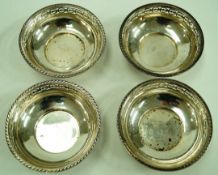 A set of four Walker and Hall silver bon bon dishes, of circular form with pierced rim,
