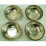 A set of four Walker and Hall silver bon bon dishes, of circular form with pierced rim,