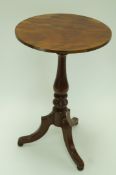 A mahogany tripod table with turned support, splayed legs and bun feet, 72cm high,