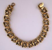 A 9 carat gold bracelet, Birmingham 1993, of beaded S scroll and baton links,