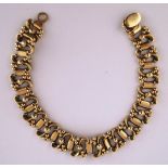 A 9 carat gold bracelet, Birmingham 1993, of beaded S scroll and baton links,