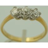 A three stone diamond 18 carat gold ring, the uniform brilliant cuts, centre stone an old cut,