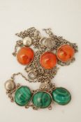 A malachite and white metal necklace and another set with cornelian