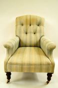A Victorian arm chair with button back, turned front legs,