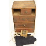 A wooden cabinet containing Hardy reel spares,