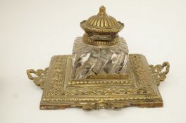 A Victorian brass square inkstand with fitted heavy moulded inkwell on four raised handles , 10.