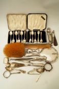 A cased set of six silver golfing tea spoons; with another cased set of silver tea spoons;