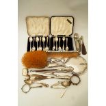 A cased set of six silver golfing tea spoons; with another cased set of silver tea spoons;