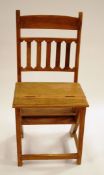 A 20th century teak metamorphic chair, the hinged seat unfolding to become a set of three steps,