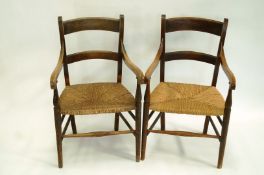 A pair of beech elbow chairs with rail backs,