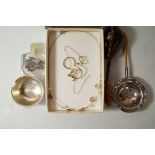 A silver tea strainer and stand,