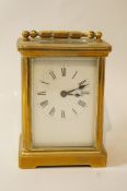 A brass framed carriage clock with rectangular white enamel dial, 14.