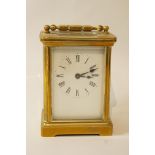 A brass framed carriage clock with rectangular white enamel dial, 14.