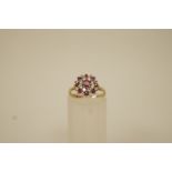 A ruby and cubic zirconia cluster 9 ct gold ring, finger size K, 2.