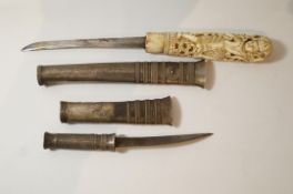 An early 20th century Burmese ivory and silver Dha knife, 23cm long and another silver, 13.