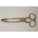 A pair of George III silver sugar nips, partial makers mark and lion passant only,