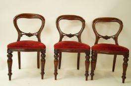 A set of six mahogany balloon back chairs including two carvers