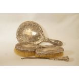 A silver dressing table set, comprising a hand mirror,