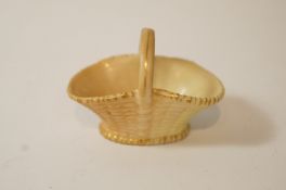 A Royal Worcester blush ivory miniature basket, picked out in gilt with gold marks, 4cm high,