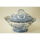 A 19th century pottery soup tureen, cover and ladle printed in blue with baskets of flowers,