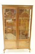 A 20th century mahogany display cabinet with glazed doors, 60cm high, 94.5cm long, 25.