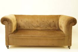 A 19th century button back Chesterfield on bun feet, upholstered in brown fabric, 79cm high,