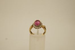 A 9 ct gold cluster ring, between crossover shoulders, finger size L, 3.