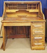 A 20th century oak twin pedestal roll top writing desk