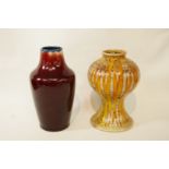 A Corbridge stoneware vase with red glaze, impressed marks, 17cm high,