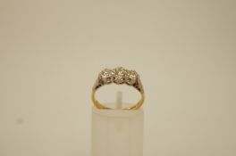 A three stone diamond 18 ct gold ring,