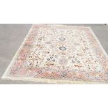 A woollen rug with stylised flowerheads on a cream field within one large band,