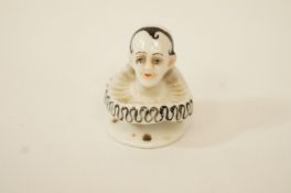 A German porcelain Pierrot's head with flared pierced base,