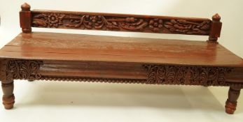 An Indian Rajastani garden day bed with carved low back and frieze, 184cm long,