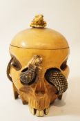 A 19th century Japanese boxwood tobacco jar in the form of human skull,