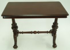 A Victorian mahogany centre table with carved balustre supports linked by a stretcher on carved