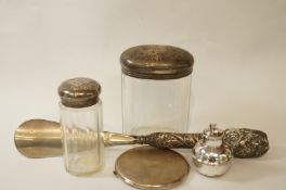 A silver compact; two glass toilet jars with silver covers;