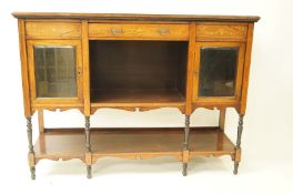 An Edwardian rosewood and marquetry credenza base, with one frieze drawer above two glass doors,