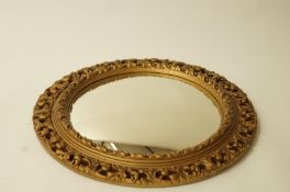 A 20th century gilt framed round mirror,