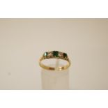 A five stone emerald and diamond ring, stamped '18ct',