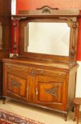 An Edwardian mahogany sideboard with mirrored back and carved with Art Nouveau style panels,