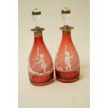 A pair of Victorian Mary Gregory style decanters and stoppers,