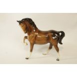 A decorative brown ceramic horse figure,