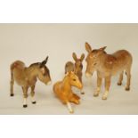 Three Beswick figures of donkey's, printed marks, 13cm to 11.