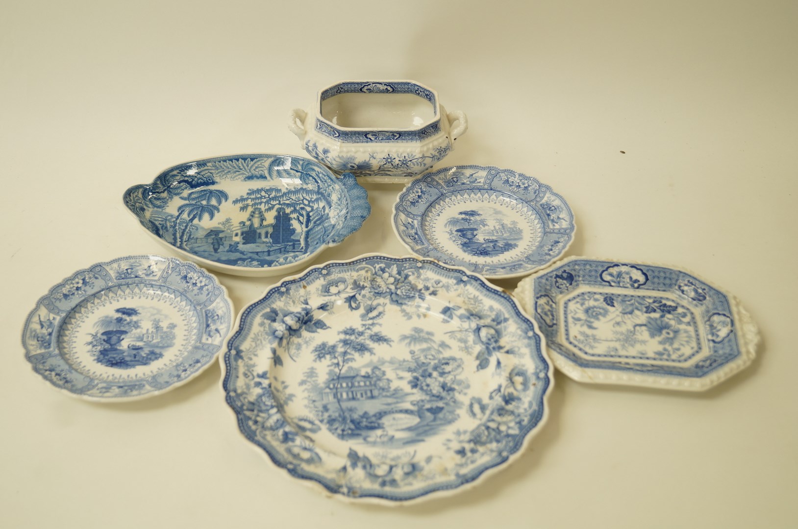 A Davenport pearlware shaped dish printed in blue with two chinoiserie figures,