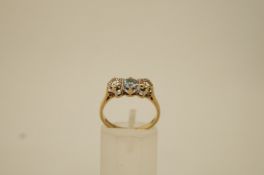 An aquamarine and diamond three stone 9 ct gold ring,